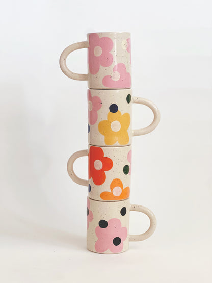 This handmade ceramic mug features a charming design of large dots over delicate flowers, perfect for any flower lover. Made with care and attention to detail, this mug is a beautiful addition to any kitchen. Enjoy your favorite beverage while admiring the intricate artistry of this unique piece. Crafted to bring joy and beauty to your daily routine.