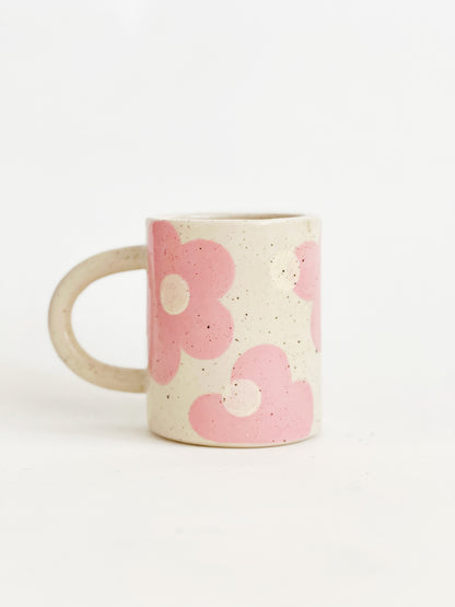 This handmade ceramic mug features a charming design of large dots over delicate flowers, perfect for any flower lover. Made with care and attention to detail, this mug is a beautiful addition to any kitchen. Enjoy your favorite beverage while admiring the intricate artistry of this unique piece. Crafted to bring joy and beauty to your daily routine.