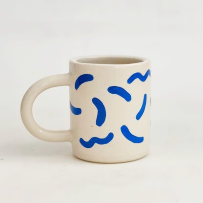 The fun squiggles design adds a touch of whimsy to your cup of coffee or tea. Made by hand, this ceramic mug is durable and perfect for everyday use. Enjoy your favorite beverage in style with our unique Squiggles Mug.