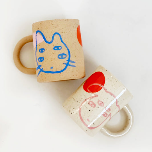 Introducing our Large Little Four Eyes Handmade Ceramic Mug, featuring our signature design inspired by our adorable and beloved pet, Bowl. This cute and unique mug is perfect for pet lovers. Handcrafted with care, it's the perfect addition to your morning routine. Brighten up your day with every sip!