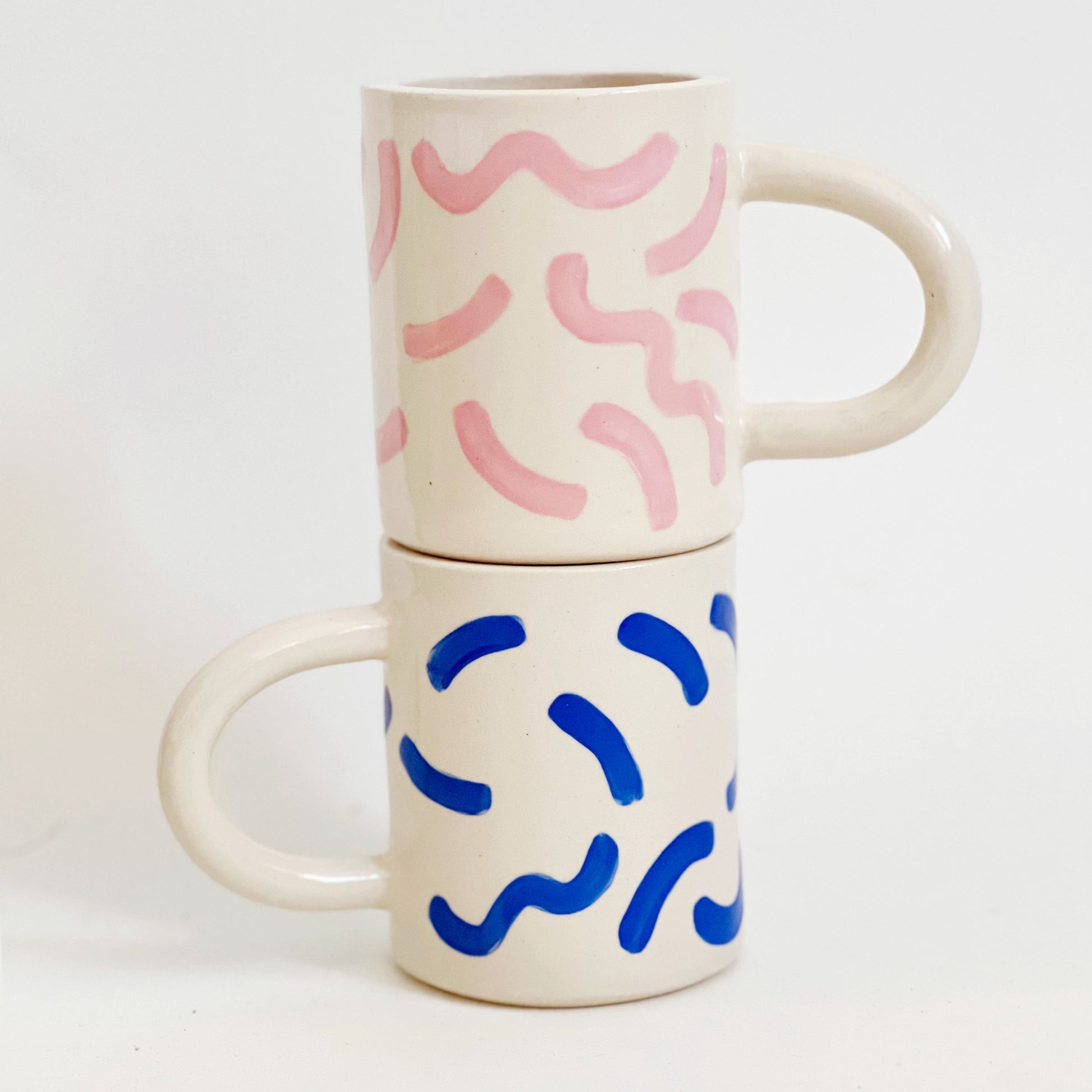 The fun squiggles design adds a touch of whimsy to your cup of coffee or tea. Made by hand, this ceramic mug is durable and perfect for everyday use. Enjoy your favorite beverage in style with our unique Squiggles Mug.