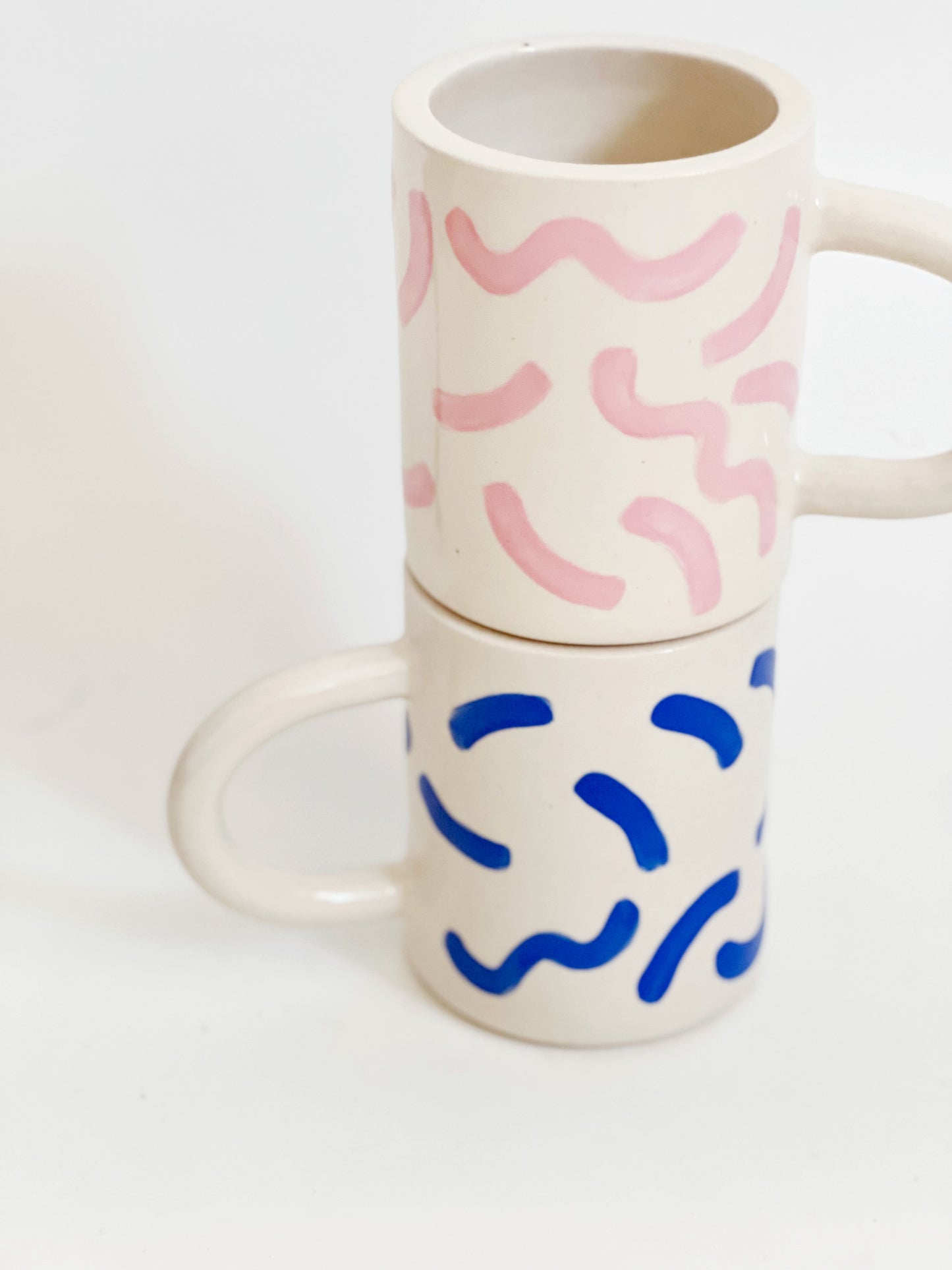 The fun squiggles design adds a touch of whimsy to your cup of coffee or tea. Made by hand, this ceramic mug is durable and perfect for everyday use. Enjoy your favorite beverage in style with our unique Squiggles Mug.