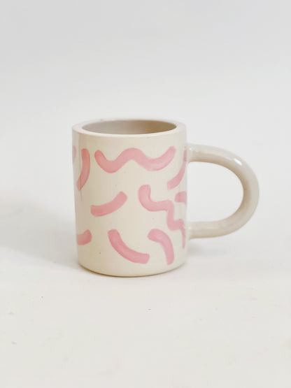 The fun squiggles design adds a touch of whimsy to your cup of coffee or tea. Made by hand, this ceramic mug is durable and perfect for everyday use. Enjoy your favorite beverage in style with our unique Squiggles Mug.