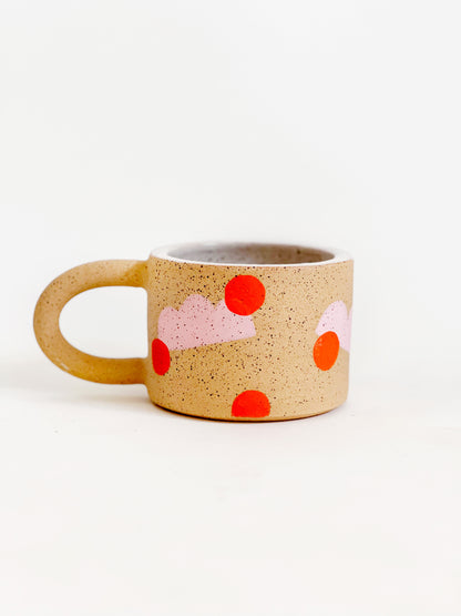 This handmade ceramic mug features playful polka dots over different shapes, adding a colorful and fun touch to your daily coffee or tea routine. Handcrafted with attention to detail, this unique mug is a must-have for any ceramic collection. Enjoy your favorite drink in a playful yet elegant way.