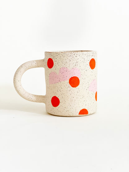 This handmade ceramic mug features playful polka dots over different shapes, adding a colorful and fun touch to your daily coffee or tea routine. Handcrafted with attention to detail, this unique mug is a must-have for any ceramic collection. Enjoy your favorite drink in a playful yet elegant way.